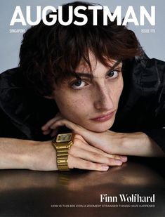 a magazine cover with an image of a woman wearing a watch on her wrist and looking at the camera