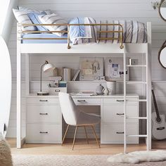 a white loft bed with desk and chair in a bedroom next to a wall mounted mirror