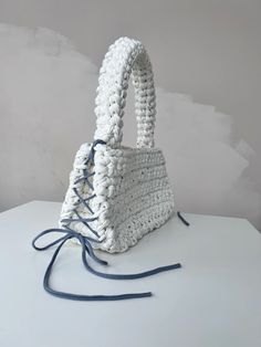 a white purse sitting on top of a table