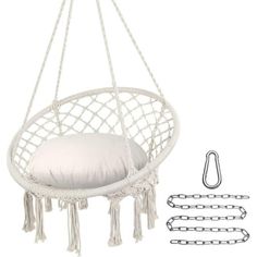 a white hanging chair with pillows and chains