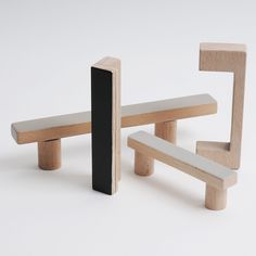 two wooden benches and one black bench on a white background