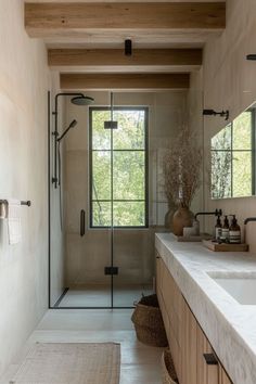 a bathroom with two sinks and a shower