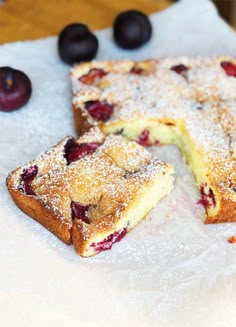 a piece of cake that has been cut into pieces and is sitting on some paper