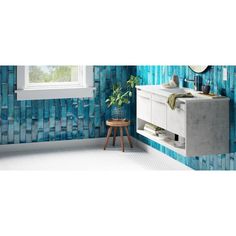 a bathroom with blue tiles on the walls and floor, along with a white sink