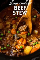 beef stew in a slow cooker with a wooden spoon and text overlay that says slow cooke beef stew