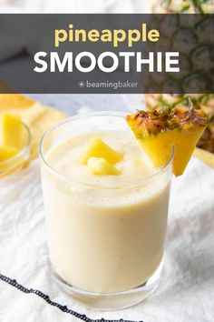 a pineapple smoothie in a glass garnished with sliced pineapple