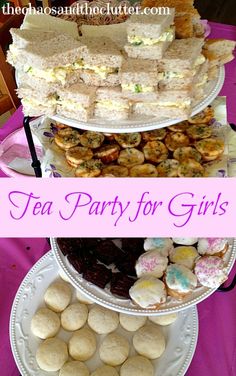 three tiered trays filled with sandwiches and pastries on top of a purple table cloth