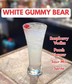 a white gummy bear cocktail sitting on top of a table