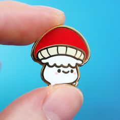 The smallest, cutest little mushroom! Add some woodland cuteness to your life with this super sweet mushroom buddy illustrated by our talented artist Sugarnova! He's so tiny, we love him! Your new favorite pin! About this item: .75 inches tall Gold plated hard enamel pin Rubber clasp on the back Kawaii Cottagecore, Little Mushroom, Pin Ideas, Enamel Pin Collection, Bag Pins, Pretty Pins, Pin Art, Mushroom Art, Cool Pins