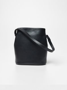 The Clover Bucket Bag is a versatile leather accessory crafted from 100% cowhide, featuring a unique four-leaf clover design when viewed from above and can be worn as a tote, shoulder, or crossbody bag. The thoughtfully designed interior includes open pockets and a secure zipper compartment, with strong magnets at the top for closure and snap buttons to maintain the bag's distinctive bucket shape. Made by experienced craftsmen, this timeless piece exemplifies quiet luxury with its clean finishing and refined details, while offering practical functionality with dimensions of W 25.5 × H 30 × D 15 cm and weighing 540g.Country of Origin: ChinaColor: Black, Brown, Deep Green, Suede Brown Strong Magnets, Clover Design, Leather Accessory, Green Suede, Quiet Luxury, Leaf Clover, Four Leaf Clover, Deep Green, Leather Accessories