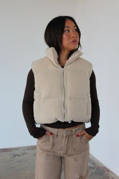 Our Theo vest is a cropped vest made from warm teddy fabric with padding that offers adequate warmth. It features a front zip, side pockets and a adjustable drawstring waist band. Model is 5’2 wearing a small Tan Sherpa Vest Outfit, Teddy Vest Outfits For Women, Teddy Vest Outfit, Crop Vest Outfit, Cropped Vest Outfit, Sherpa Vest Outfit, Fleece Vest Outfit, Cream Teddy Bear, Vest Outfits For Women