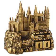 a gold trophy with a castle on top and the words march 11 written below it