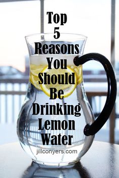 a pitcher filled with lemon water sitting on top of a table