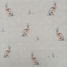 a fabric with rabbits on it and snowflakes in the backgroung