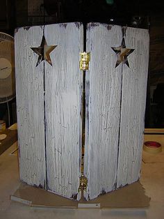 an old wooden door with two stars on the top and bottom, is being worked on