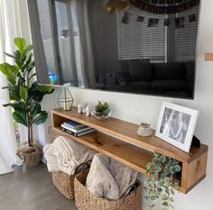 a living room filled with furniture and a flat screen tv mounted to the side of a wall