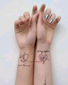 two wrist tattoos with words on them