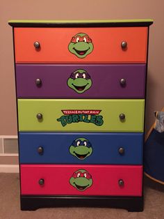 a colorful dresser with teenage mutant stickers on it