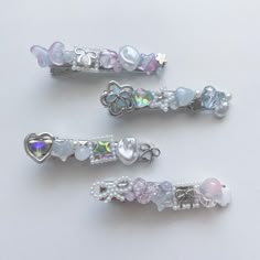 three hair clips with different designs on them