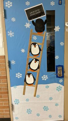 a door decorated with penguins and snowflakes