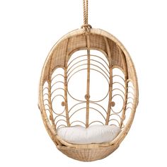 a rattan hanging chair with white pillows