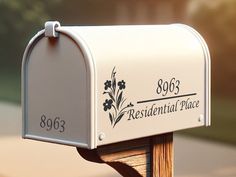 a white mailbox sitting on top of a wooden post