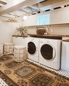 a washer and dryer sitting in a room next to each other on top of a rug