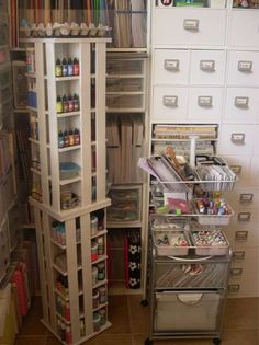 an organized closet with lots of drawers and bins in the corner, including file cabinets