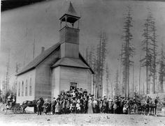 an old black and white photo of people standing in front of a church