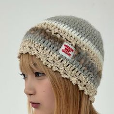 a girl wearing a hat with a button on it