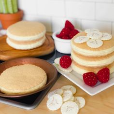 pancakes with strawberries and bananas on plates