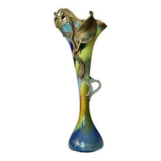 a blue and green vase sitting on top of a table