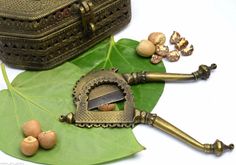 some nuts are sitting on top of a green leaf next to a knife and other items