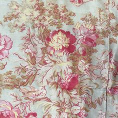 an image of a flowery fabric with pink and yellow flowers on it's side