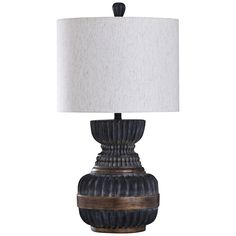 a black and brown lamp with a white shade on it's base, against a white background