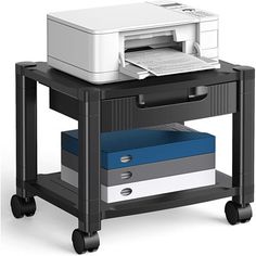 a printer sitting on top of a black cart