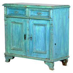 an old blue cabinet with two doors and one drawer on the bottom, is shown