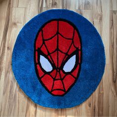 a blue rug with a spiderman face on it