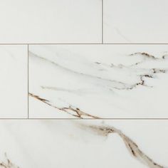 white marble tiles with brown streaks on them