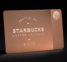 a starbucks card sitting on top of a table