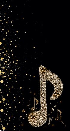 a black background with gold dots and a musical note