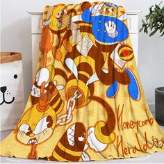 a yellow blanket with cartoon characters on it