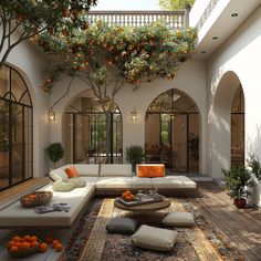 an outdoor living room with oranges on the tree