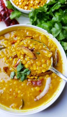 two bowls filled with soup and garnished with cilantro