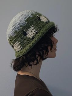 a woman wearing a green and white crocheted hat