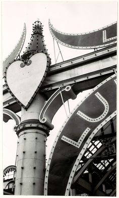 a large clock tower with a heart on it's side