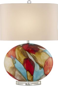 a table lamp with a glass base and a light shade on it's side