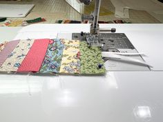 a sewing machine with several pieces of fabric on it