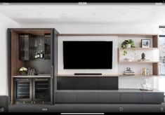 an entertainment center with built - in shelves and a flat screen tv mounted on the wall