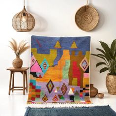 a multicolored area rug in the corner of a room with potted plants